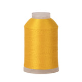 Spool of yellow thread on a white background