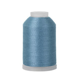 Spool of blue thread on a white background