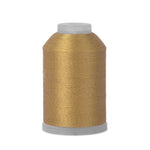 Spool of gold thread on a white background