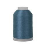 Spool of blue thread on a white background