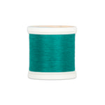 Teal green thread wound on white plastic spool with visible thread texture and clean edges