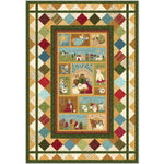 A festive Christmas quilt featuring nativity scenes and holiday imagery surrounded by colorful diamond-patterned borders in earth tones.