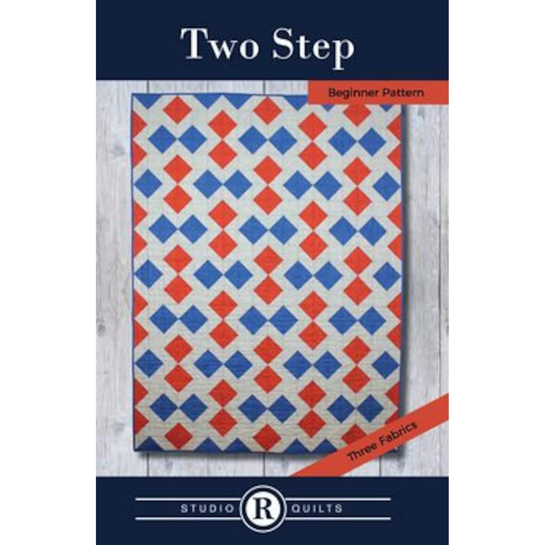 A quilt pattern cover showing a geometric design with interlocking red and blue diamond shapes on a white background, labeled as a beginner pattern using three fabrics.