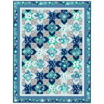 Blue and teal star and diamond pattern quilt with floral fabrics, featuring geometric blocks on gray background with decorative border