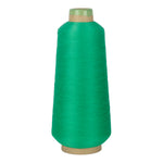 Green spool of yarn on a white background